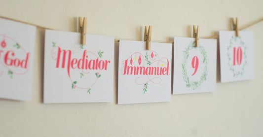 Names of Jesus Advent Calendar cards pegged to twine, showing Mediator and Immanuel