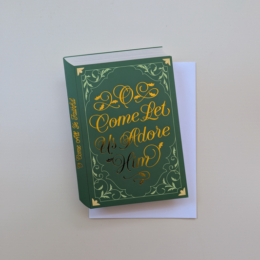 O Come Let Us Adore Him green Christmas card with gold foil, on its envelope