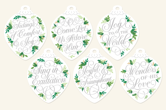 Silver script Christmas ornaments with hand-lettered carol lyrics